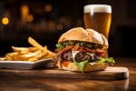 Premium Photo | A delicious bacon cheeseburger with a side of fries and a  glass of beer